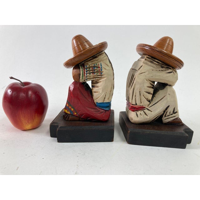 A pair of vintage 1950s North American Mexican handmade polychrome painted wood "Mexican Siesta bookends". Beautiful,...