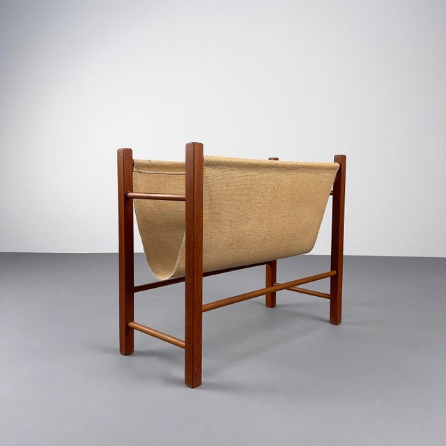 Elegant, geometric newspaper rack from Denmark. Minimalist teak frame with a linen shelf. Beautiful condition with minor...