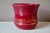 This burgundy red ceramic planter, enhanced with gold, has a pretty shape and a flared corolla neck. It is a decorative,...
