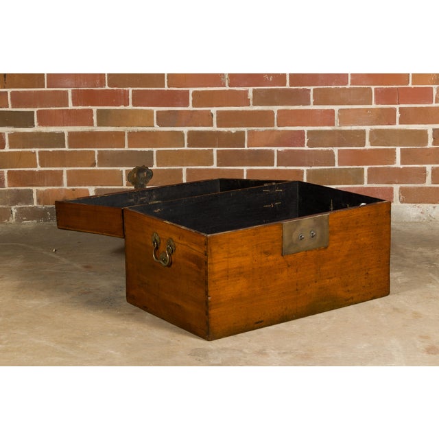 An oak or teak blanket chest from the 19th century with traditional brass lock, lateral handle and dovetail construction....