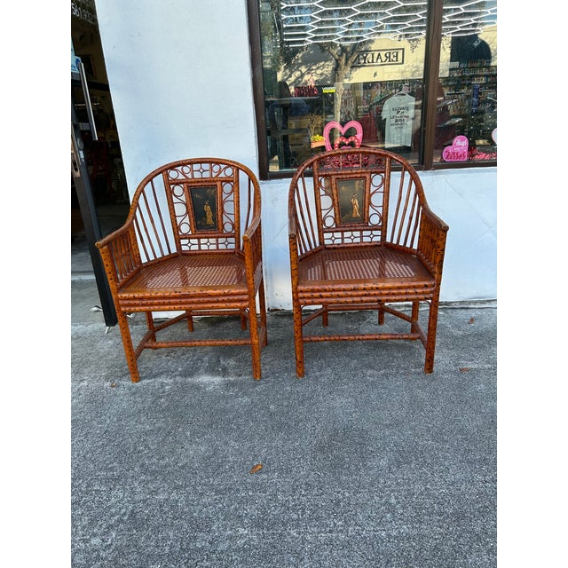 Classic vintage bamboo Brighton Pavilion armchairs featuring a faux tortoise finish and painted Figural lacquer panels.