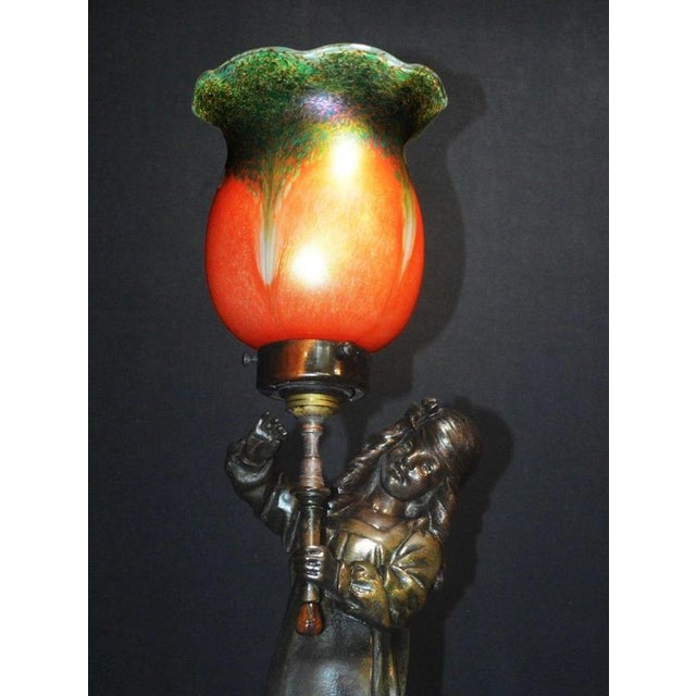 A striking french figural table lamp attributed to a.j. Scottie, dating to circa 1900, combining sculptural metalwork with...