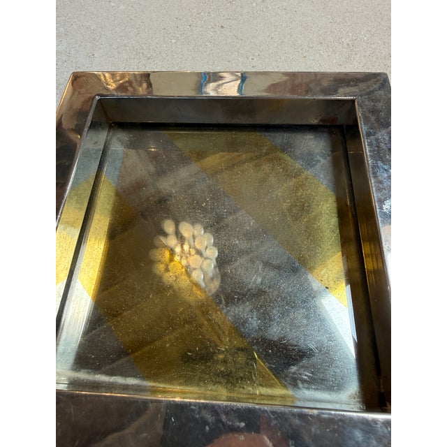 Elegant vintage catchall tray featuring a gold stripe detail base framed by a polished chrome border.