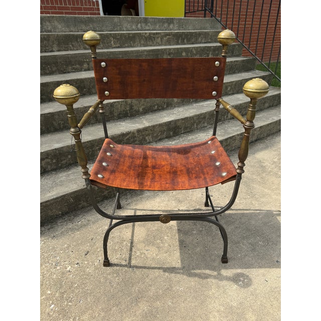 Superb hand forged iron, brass and leather curule chair. I love the size of this one. Its has grand scale. Leather has...