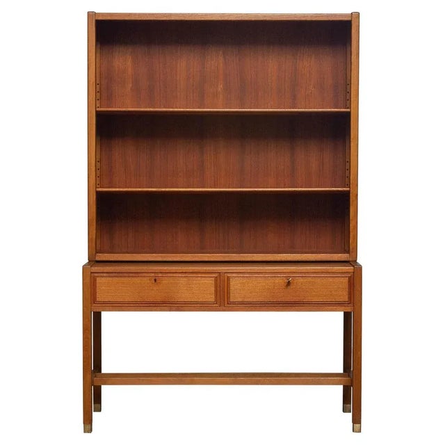 Elegant teak bookcase cabinet build up with a two lockable drawers sideboard underneath and a cabinet on top in which are...