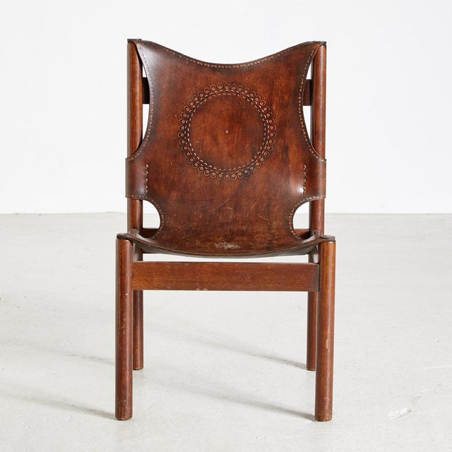 Dark oak framed lounge chair with genuine leather seat and backrest.