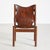 Dark oak framed lounge chair with genuine leather seat and backrest.