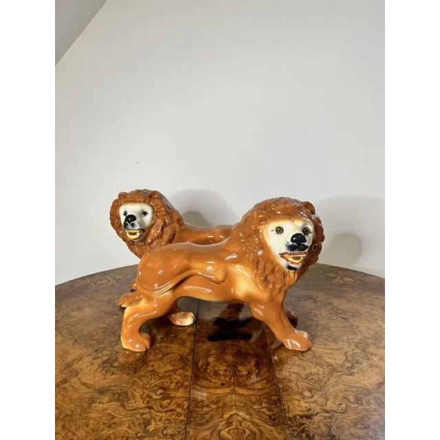 Large pair of antique Victorian Staffordshire lions having a quality pair of antique Staffordshire lions in a standing...