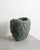 A unique contemporary stoneware vase sculpture with a i rregularly shaped green and grey-brown glazed surface by the...