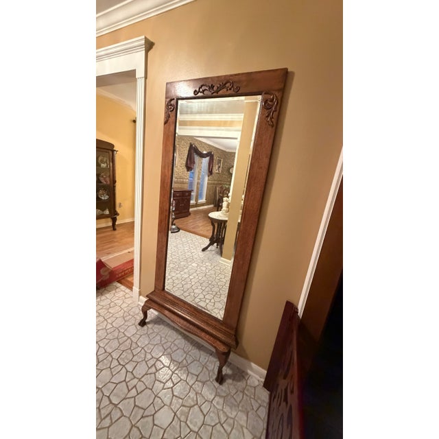 A handsome vintage oak floor mirror featuring beautifully carved decorative detailing, quarter-sawn oak grain, molded base...