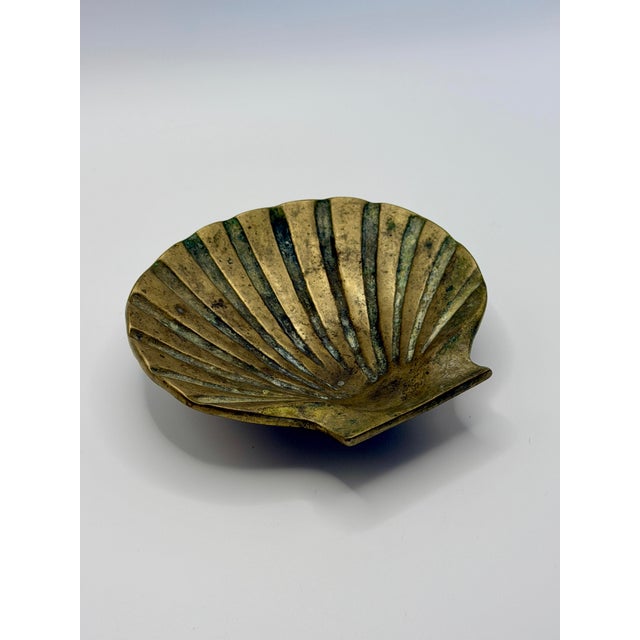 Beautiful vintage brass seashell catchall dish featuring sculptural ridged detailing and a richly aged patina throughout....