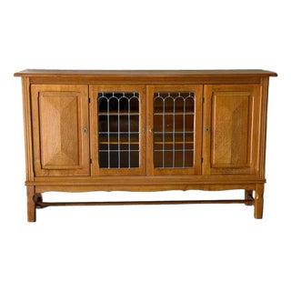 In Style of Henning Kjærnulf Oak Sideboard Credenza With Carved and Leaded Glass Doors Danish Mid-Century Modern 1970s For Sale
