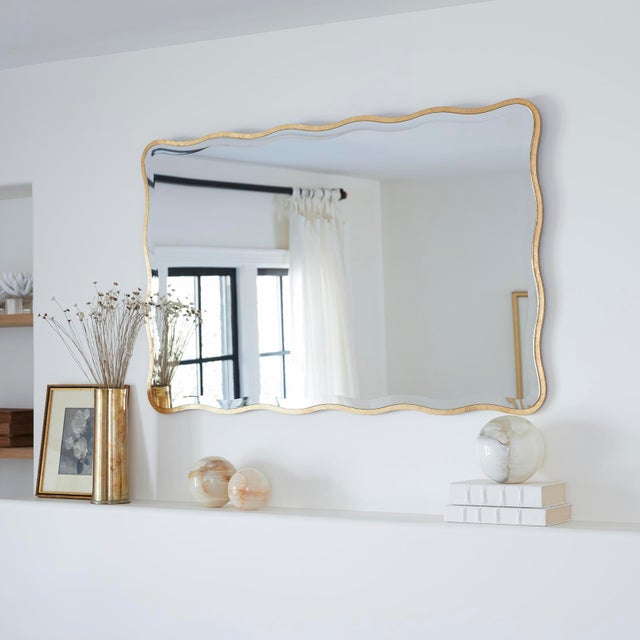 An undulating gilded frame and beveled mirror edge give the Candice mirror a feminine, glamorous look. Sure to look...