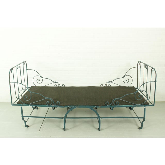 This foldable metal daybed offers a functional mid‑century aesthetic with a sturdy frame, newly replaced webbing, and...