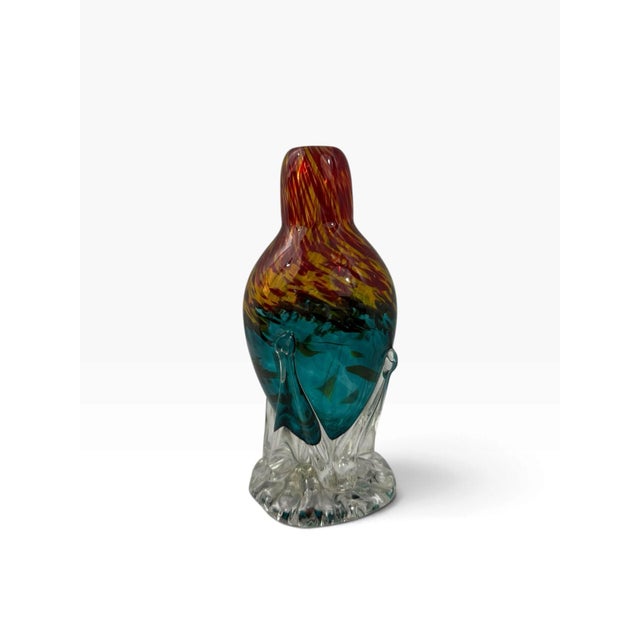 Hand-blown studio art glass vase with a dramatic pulled clear-glass foot, a deep teal body, and flame-like red and amber...