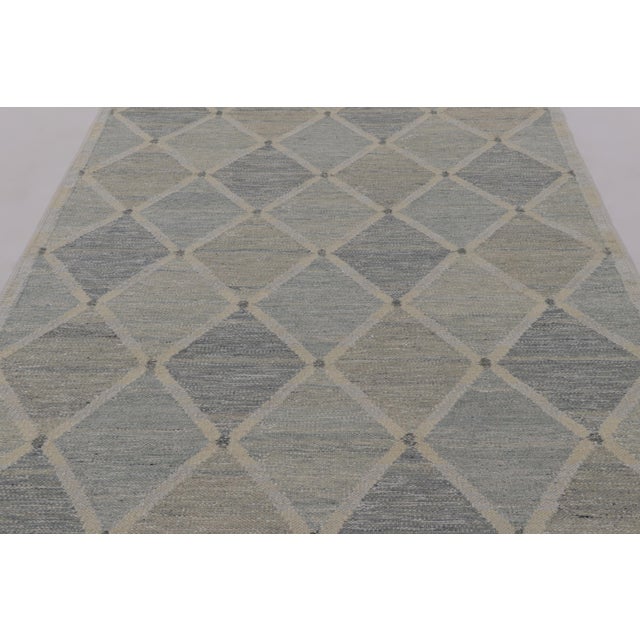 Handwoven in wool, this 6x9 flatweave is a sophisticated selection from our contemporary Scandinavian rug collection—its...