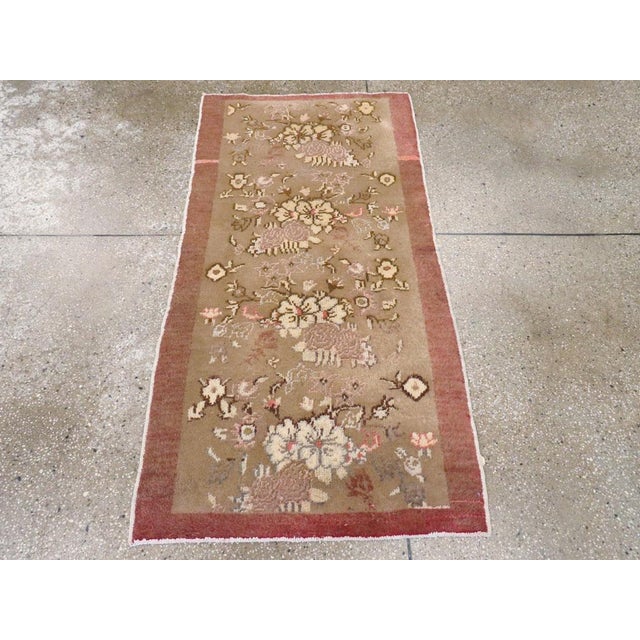 A vintage Turkish Anatolian throw rug. Four bouquets of roses and other flowers switch orientations right and left as they...