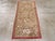 A vintage Turkish Anatolian throw rug. Four bouquets of roses and other flowers switch orientations right and left as they...