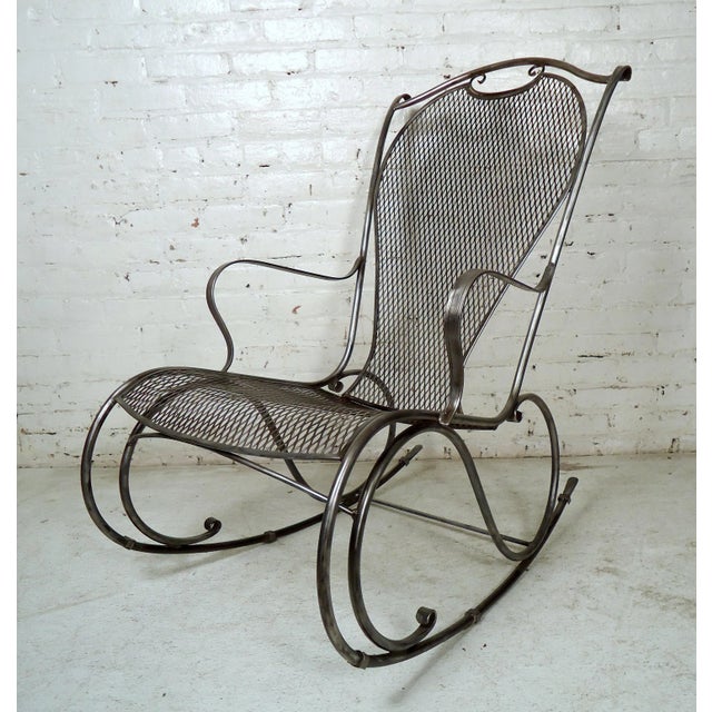 Gorgeous vintage metal rocker features a mesh seat and back, all stripped down and restored to a bare metal style finish.