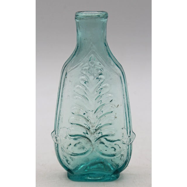 Circa 1840-60 American aquamarine glass cologne bottle. Dark aquamarine; column & plume pattern. Open pontil, blown into a...
