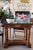 A beautiful console table crafted in richly figured walnut and topped with a striking black marble slab, circa 1820...