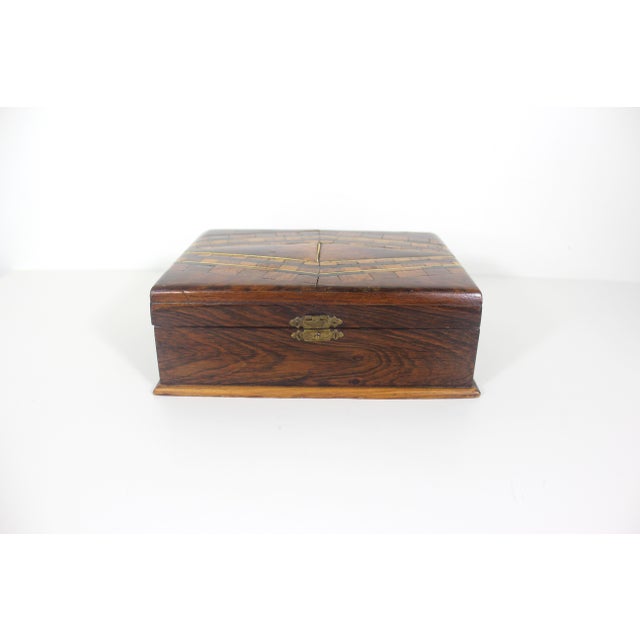 Lovely handmade wood trinket box inlaid with different kinds of exotic wood. The hinged lid opens easily. Good size...
