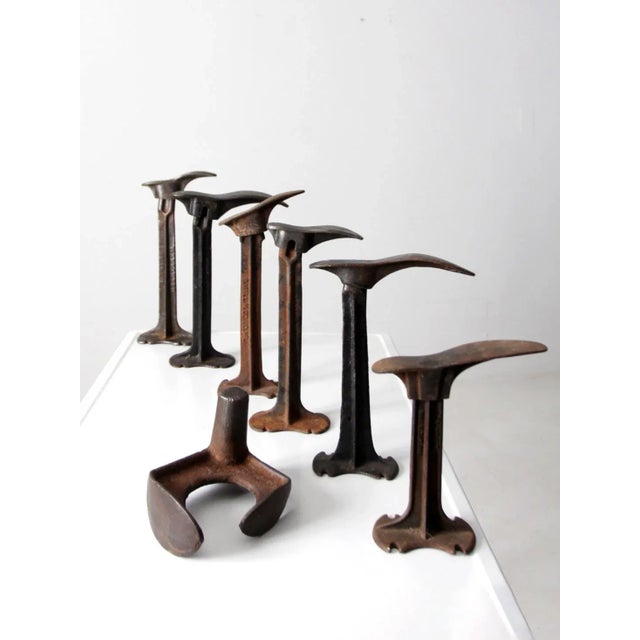 This is a collection of 19th century cast iron cobbler stands with forms, and a cobber's anvil. Used to make shoes, the...