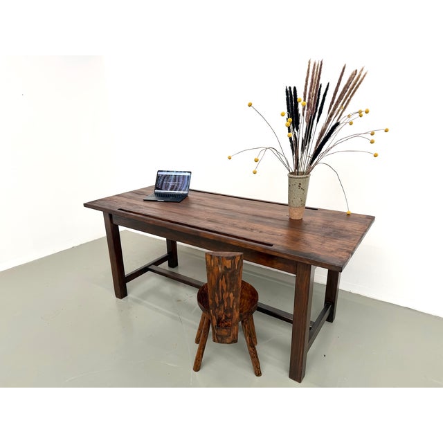 A solid pine workbench, likely from an architect's studio or technical office dating from the 1950s or 60s. The tabletop,...