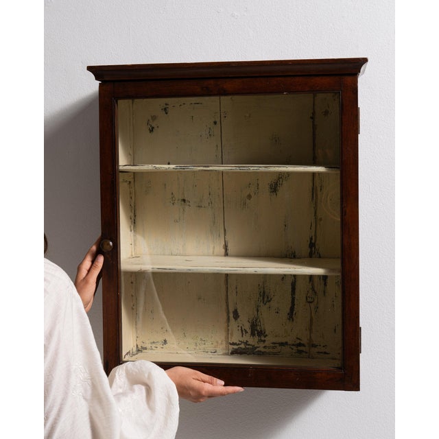 This piece presents as a cabinet, distinguished by dark mahogany, mirrored panel. It was made in France during 19th...