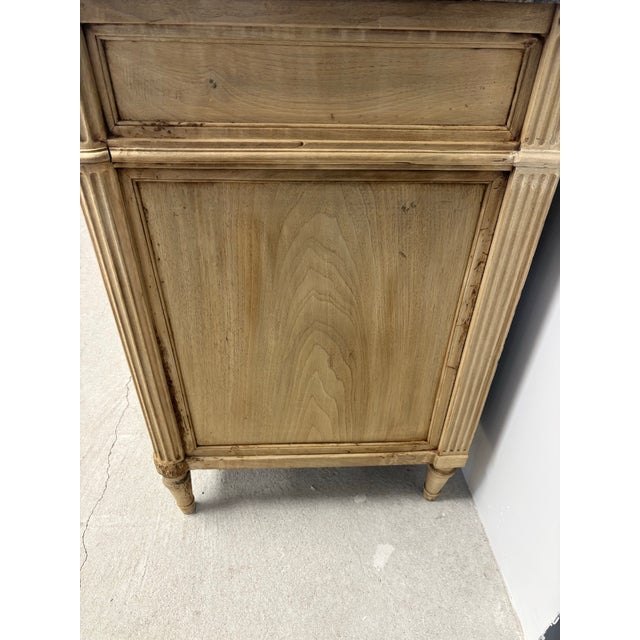 A handsome French Louis XVI style commode distinguished by its strong architectural form and beautifully timeworn bleached...