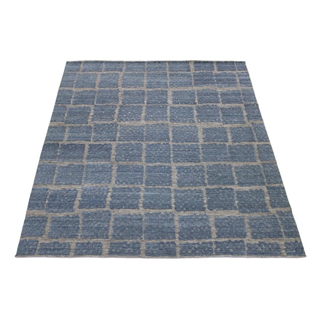 This stunning contemporary Moroccan-style hand-knotted wool rug features a captivating gray and blue abstract design,...
