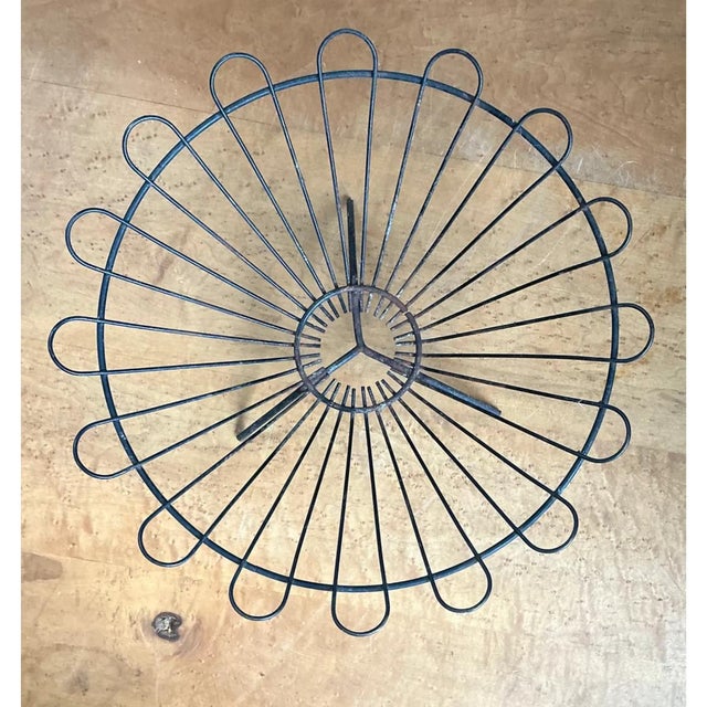This vintage wire basket is constructed in a striking radial, sunburst pattern, with slender metal spokes fanning outward...