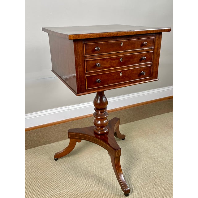 A fine English Regency period work or sewing table, crafted in quilted mahogany with rosewood crossbanding. The drawer is...