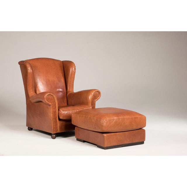 Leather Baxter armchairs with poufs. The set of 4 pieces can be split. The price refers to the complete set of four. A...