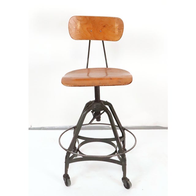Vintage industrial drafting stool, manufactured by the Toledo Metal Furniture Co. during the 1930s and 1940s. It has a...
