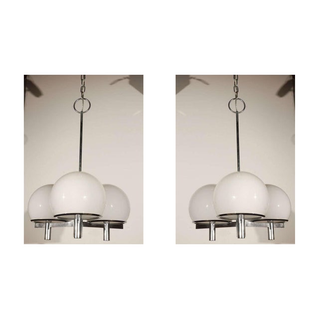 Three white globe Lightolier ceiling fixture. Two ceiling fixtures available. Three pairs of matching sconces available....