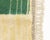 An ivory field scattered with story — architecture, color, and mark-making in quiet conversation. This hand-knotted wool...