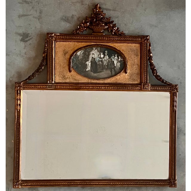 A fine Louis XVI style trumeau wall mirror in wood and gilded stucco. Its upper section features an oval-shaped...