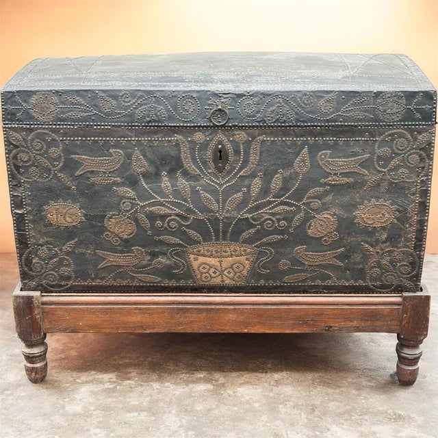 Of museum quality ! An exceptional dome top wood leather wrapped trunk with amazing nailhead decoration depicting florals...