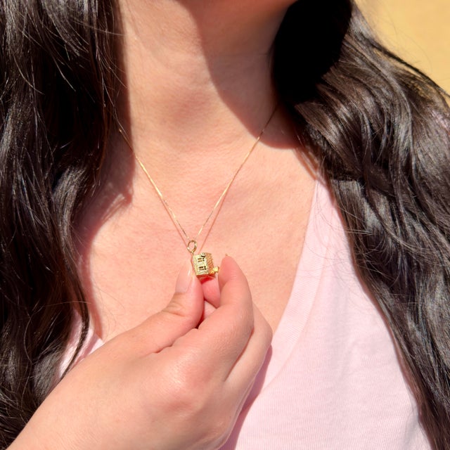 About This Charm: A treasured piece of mid-century romance, this 14K charm opens to unveil a bride and groom standing...