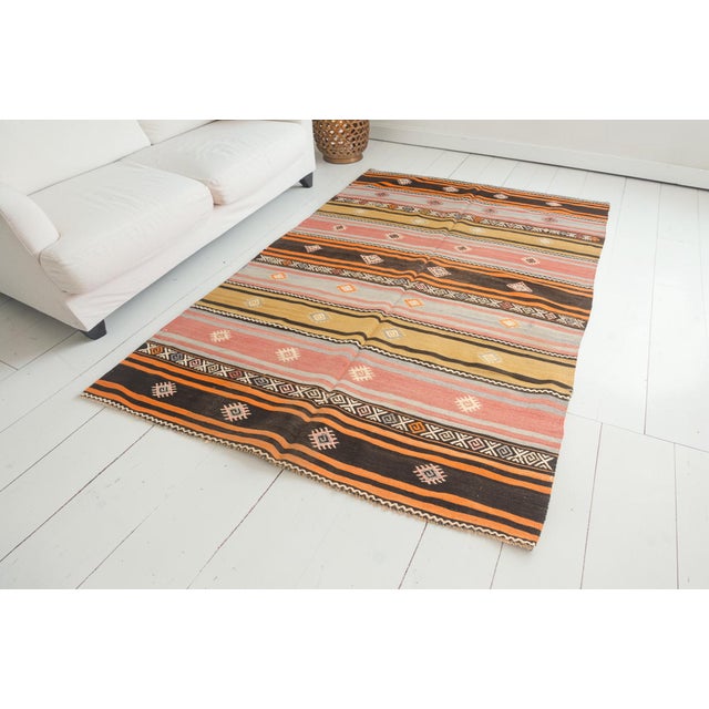 This is a vintage Turkish Oushak rug from the Mid 20th Century. The piece was hand-knotted.