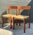 This elegant pair of Mid-Century Modern dining chairs embodies the pinnacle of Danish design principles, marrying organic...