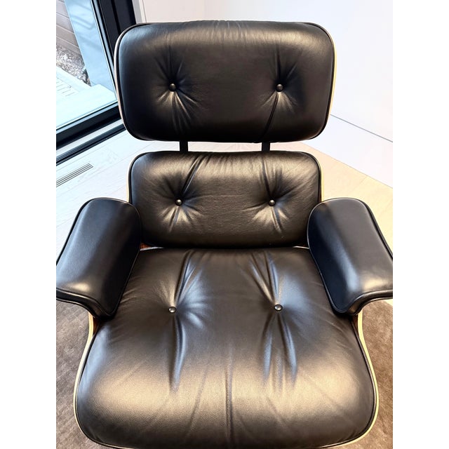 Authentic Herman Miller Eames Lounge Chair and Ottoman set, manufactured in 2017, featuring black leather upholstery and a...