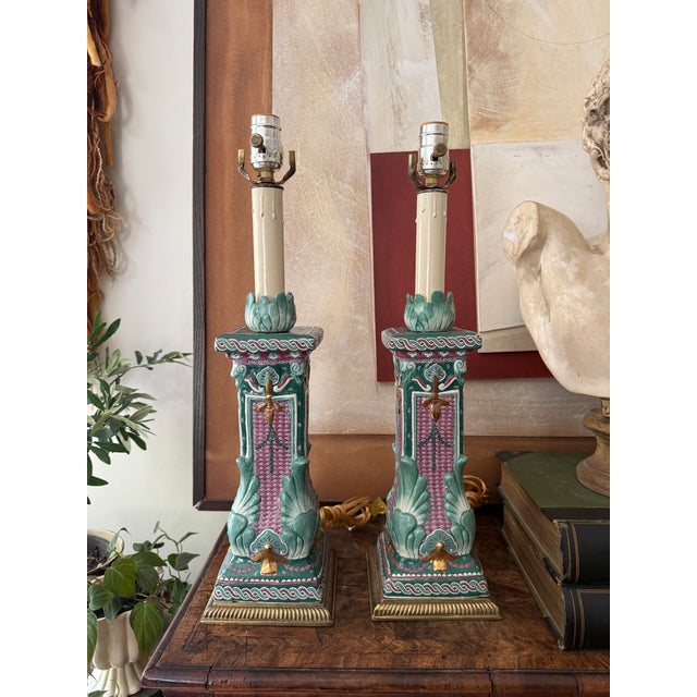 Striking pair of vintage ceramic table lamps featuring an ornate raised relief design in shades of green, pink, cream, and...