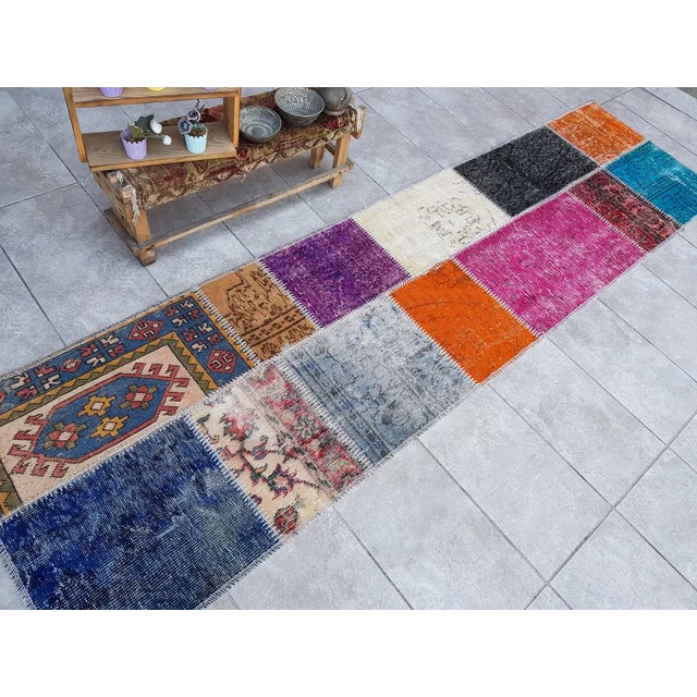 This is a vintage Turkish Oushak rug from the Mid 20th Century. The piece was hand-knotted.