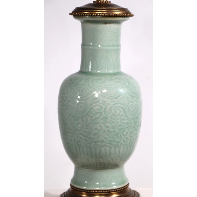 Charming decorative table lamp having a ceramic body mounted on a stylized brass base. This example is in clean, working...