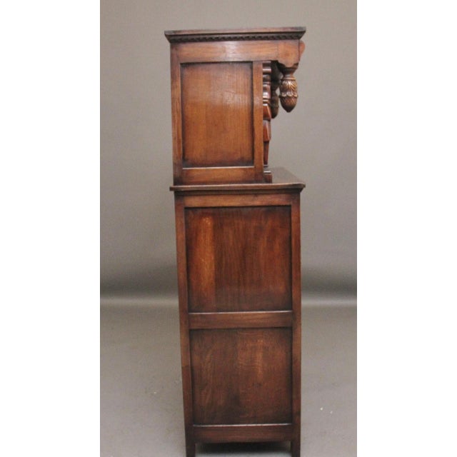 Early 20th Century carved oak court cupboard, the top section consisting of a carved frieze with hanging acorns either...