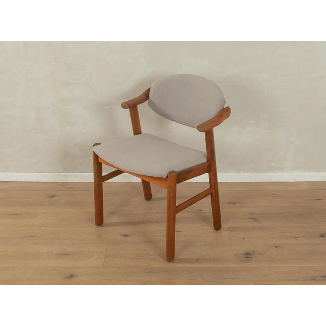 A classic desk chair by Schou Andersen from the 1950s with a teak frame. The chair has been reupholstered and covered in a...
