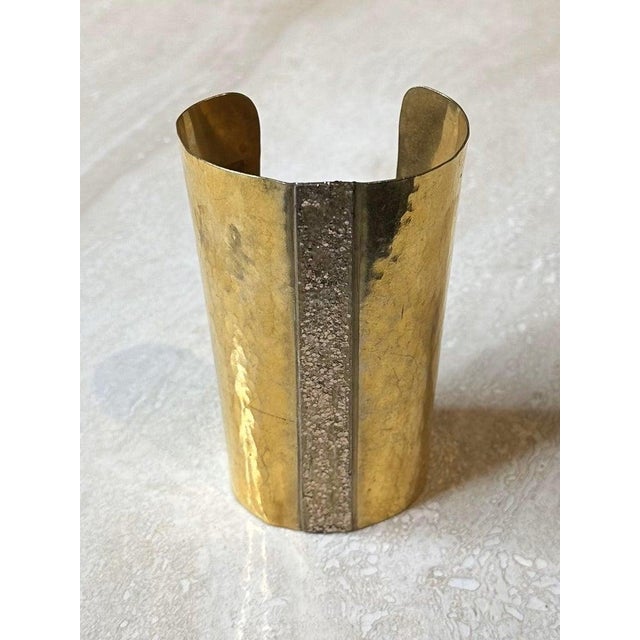 The Mary McFadden Tall Gold Cuff Bracelet is a stunning, statement-making piece of jewelry that reflects the designer's...