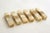 Set of 6 parallelepiped-shaped knife rests with beveled edges; all in solid veined ochre onyx stone
